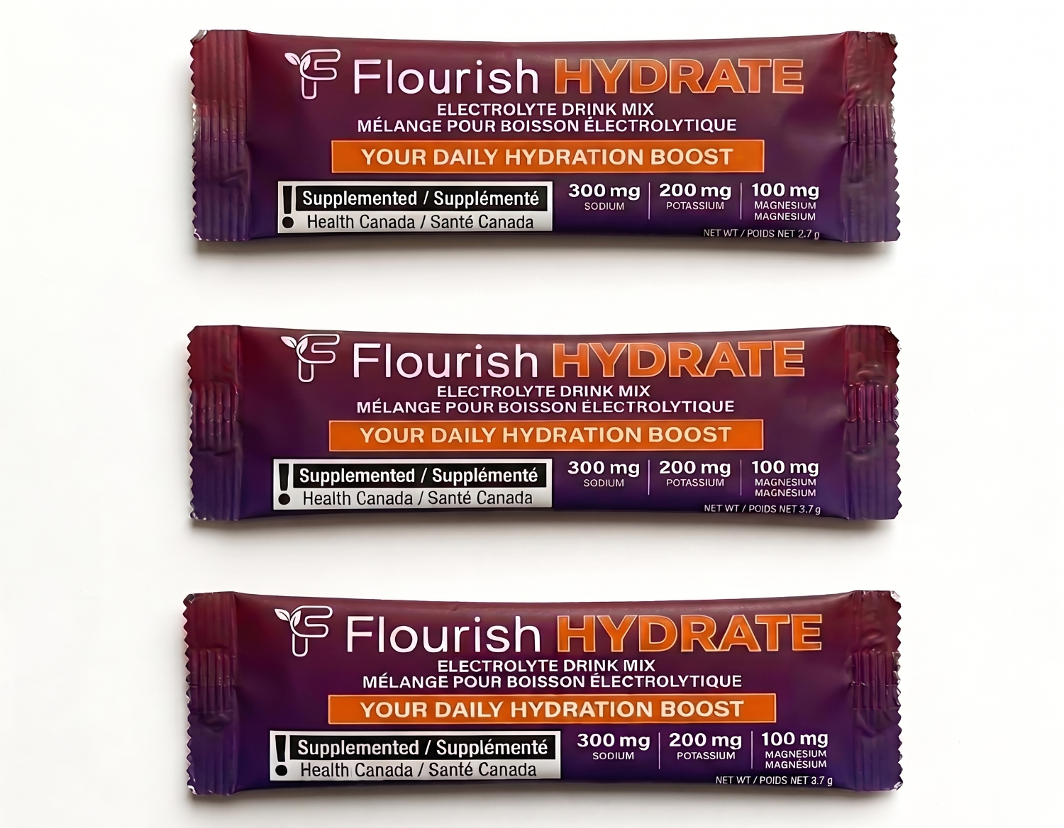 Three packages of Flourish Hydrate electrolyte drink mix on a white background